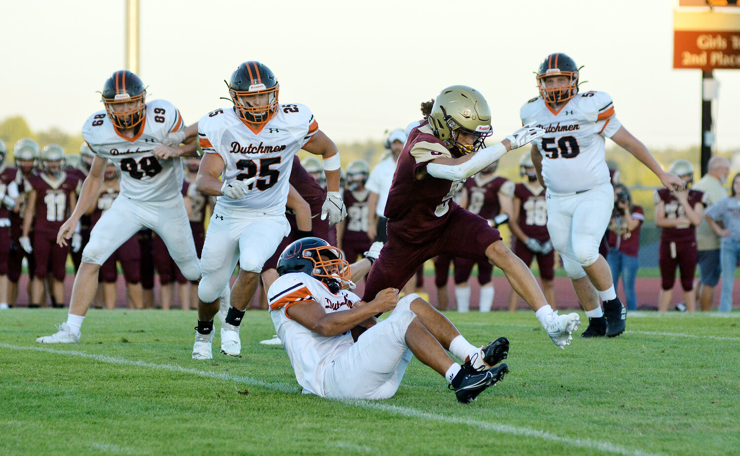 Isaiah Gates (center) grabs a hold of Eldon’s Andrew Beanland while fellow Dutchmen defenders (from left) Dalton Pyrtle, Logan Bailey and Landen Diestelkamp look to help Gates bring down the Mustang ball carrier during Owensville’s 35-31 victory Friday night at Victor Field inside Mustang Memorial Park.